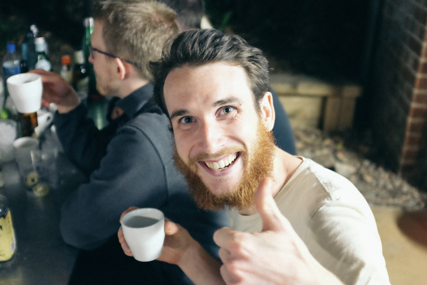 A person smiling and giving the thumbs up