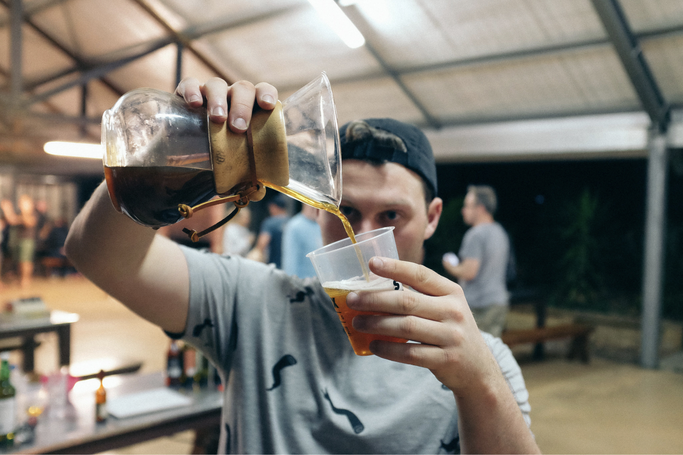 A person pouring coffee into a cup